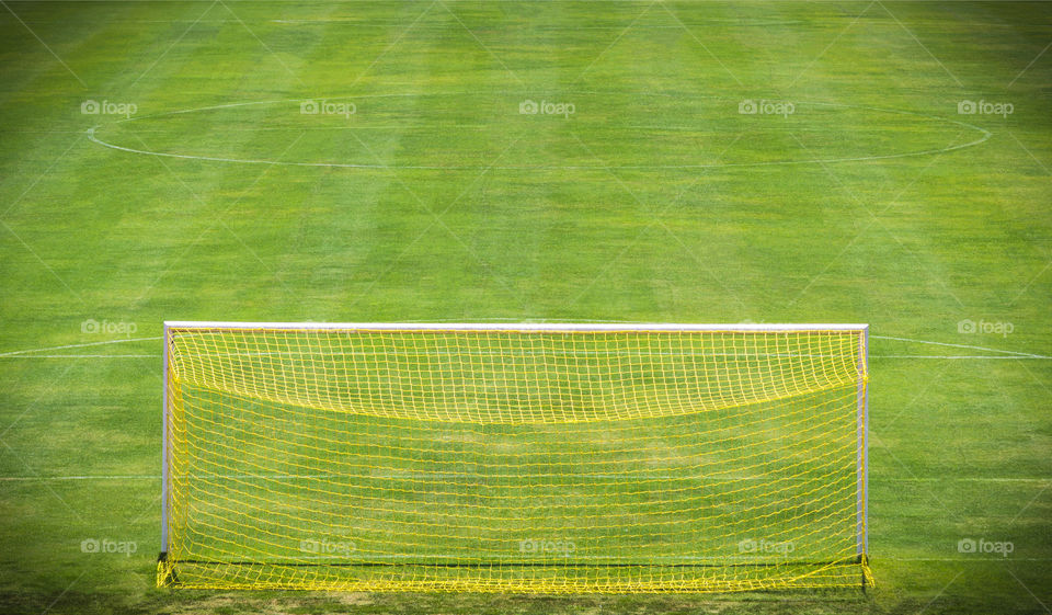 Goal net on green field