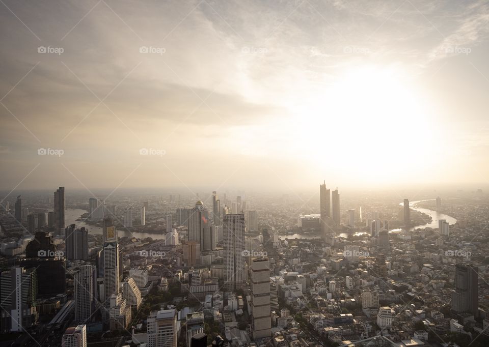 Bird eyes view over the capital city Bangkok Thailand on hot day , Mahanakorn building roof top view