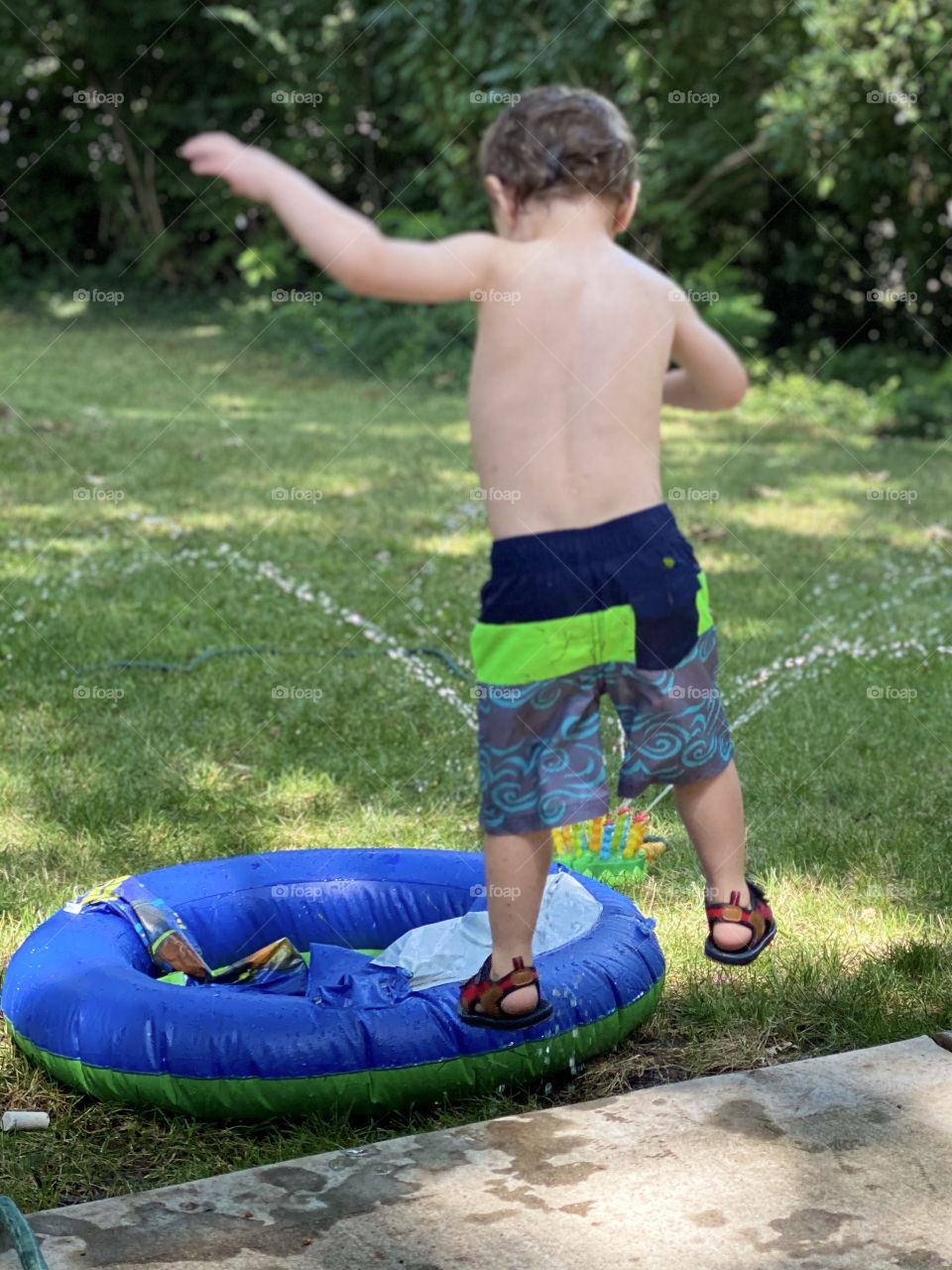 Boy jumping into pool