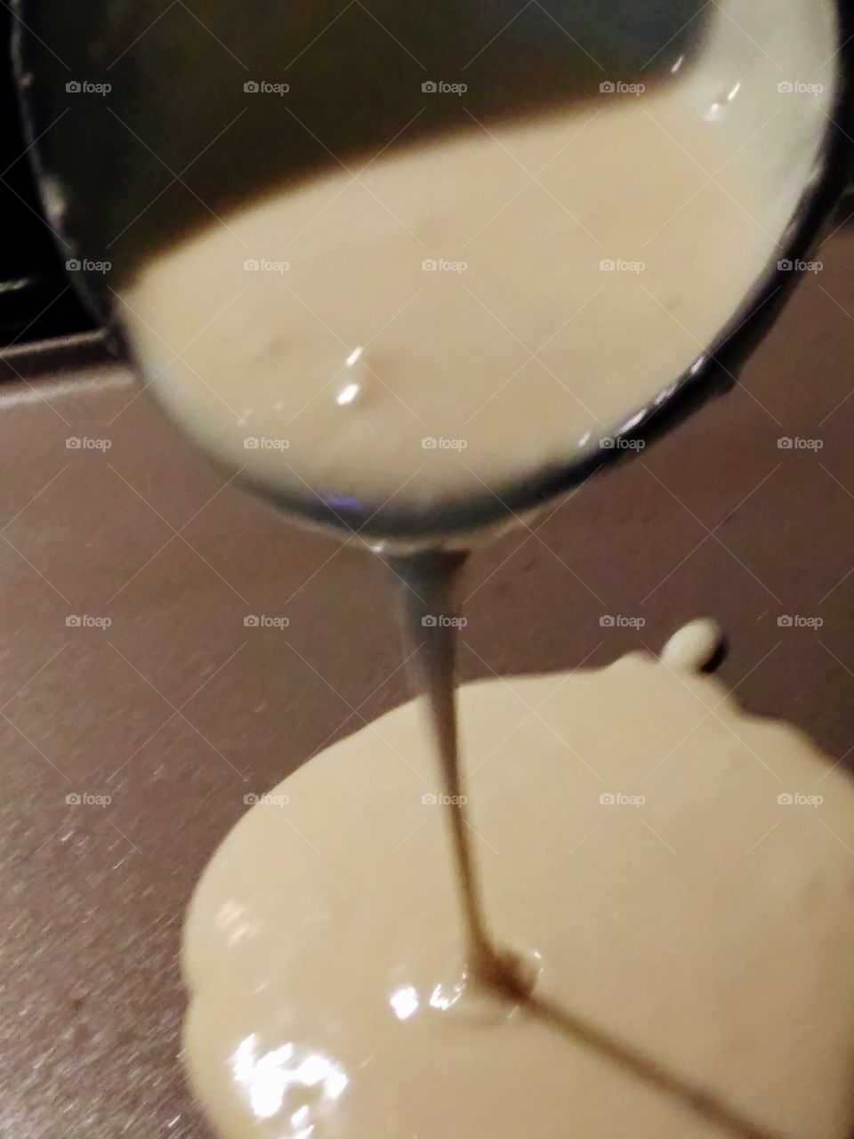 pancake batter poured onto a hot griddle