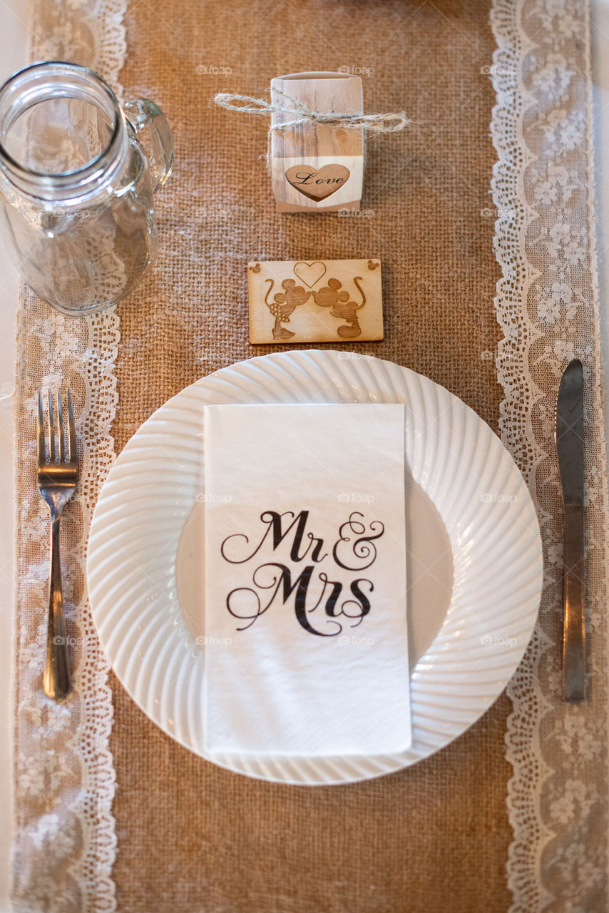 wedding ceremony table setting with white plates and momogramed napkings