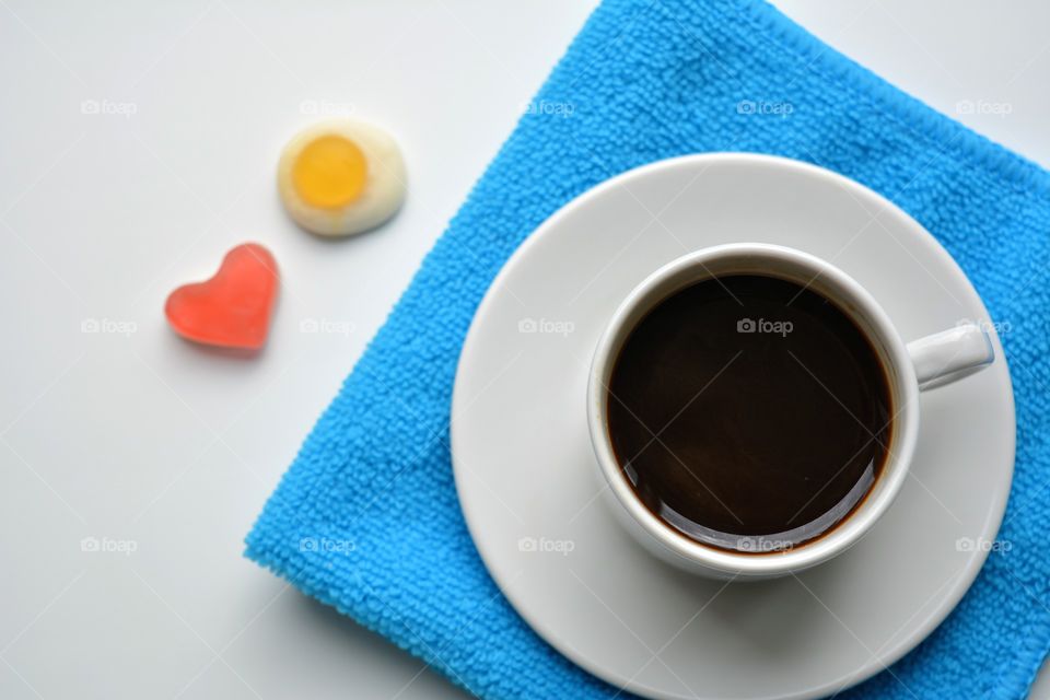 coffee cup with candy top view on a white and blue background