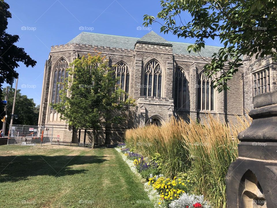 Garden at the historical building and a blue sky