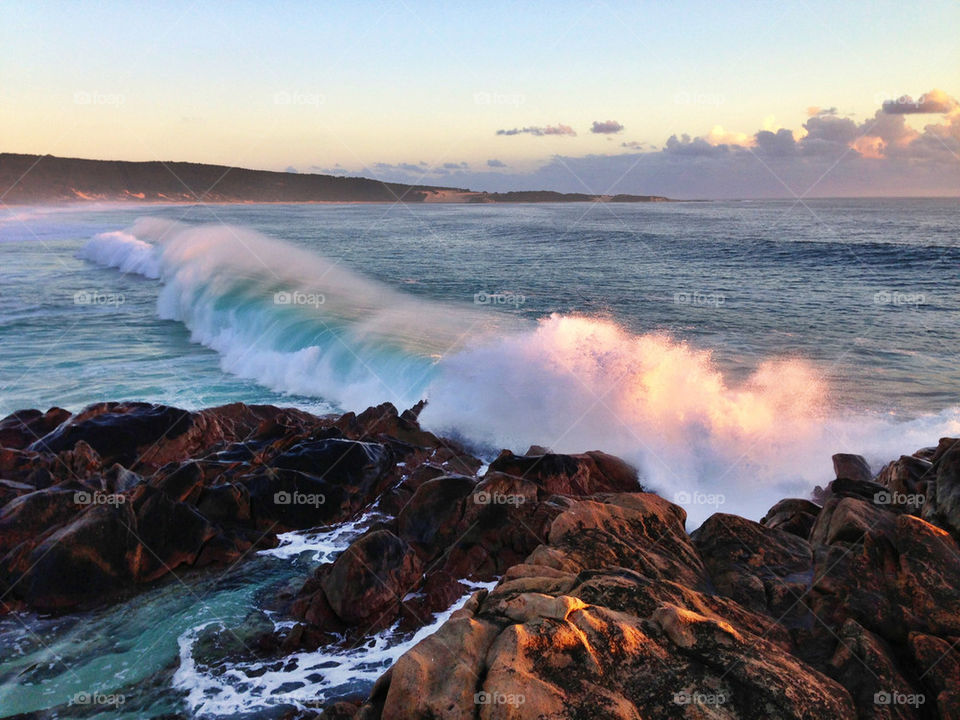 Surf breaking on rocks