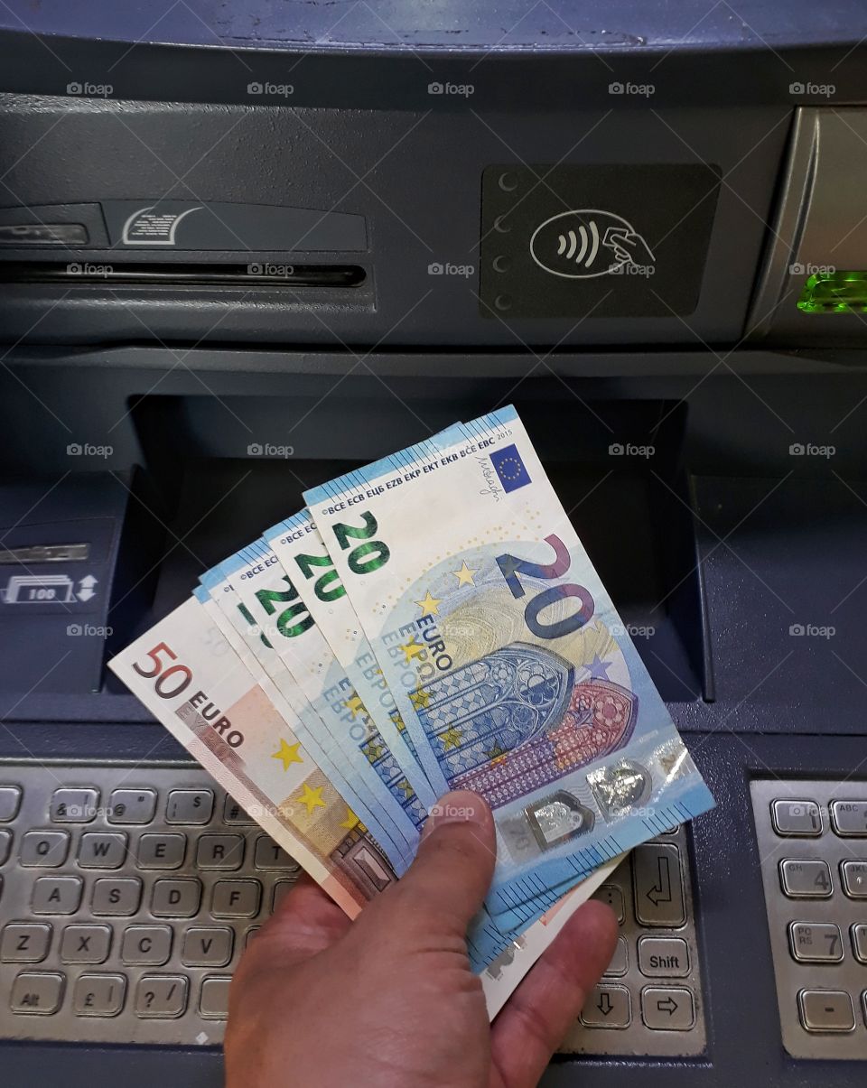 taking euro cash from cash machine- ATM