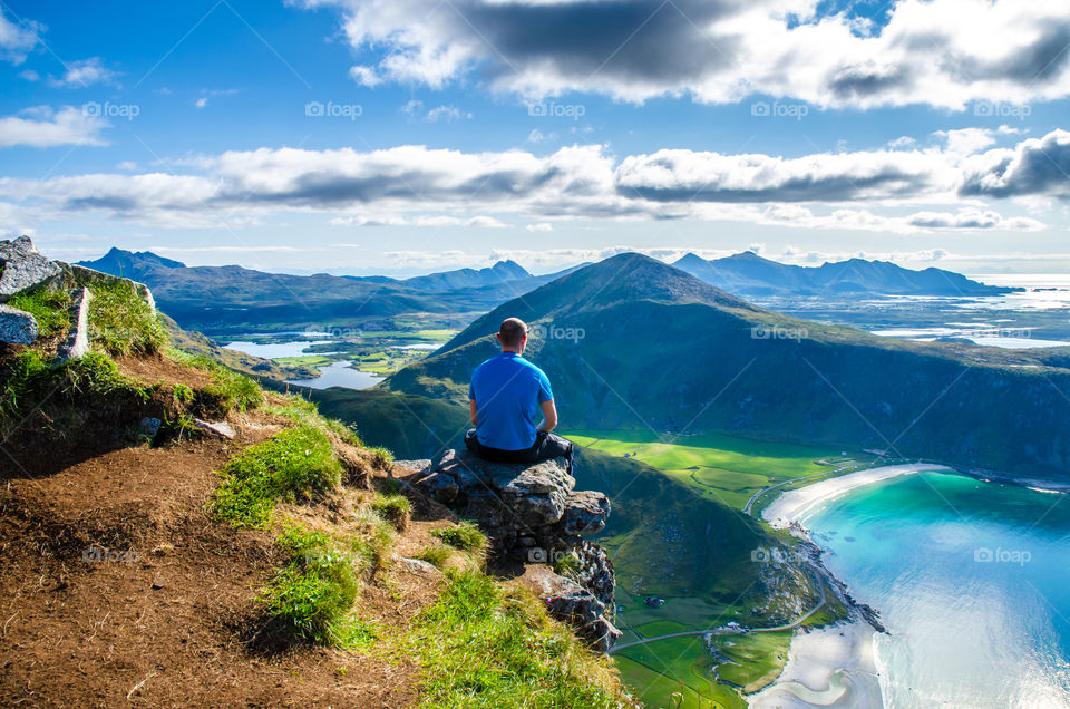 Person sitting on rock