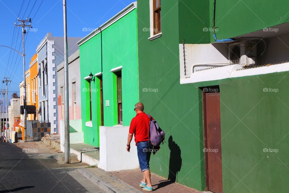 Colorful houses and a man in red t-shirt