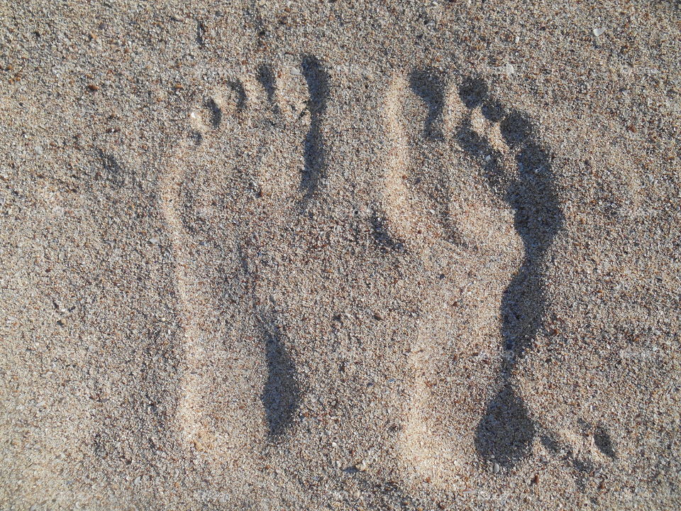 barefoot footprints on a sand sea summer vacation