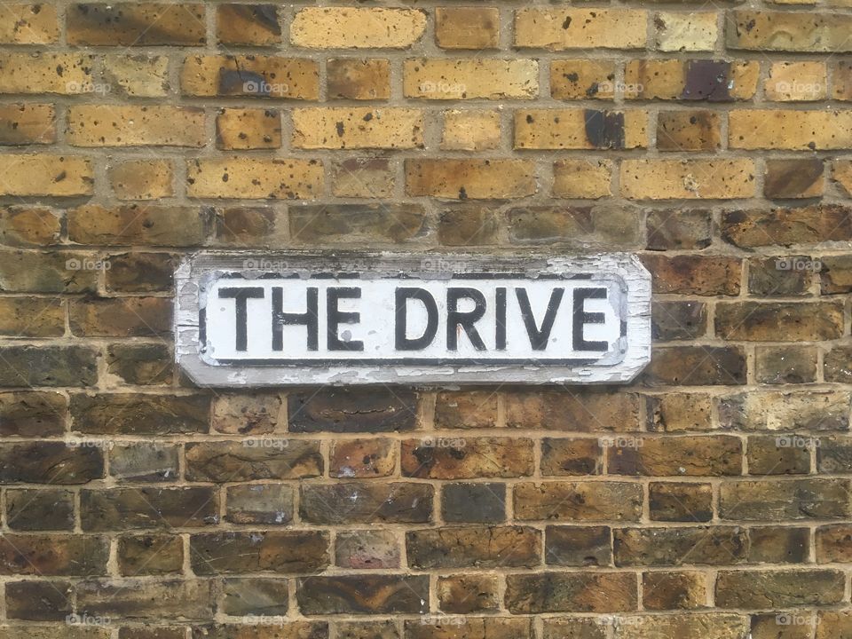 The Drive, Edgware, street sign affixed to brick wall at the Hale Lane end. Passed in Spring.