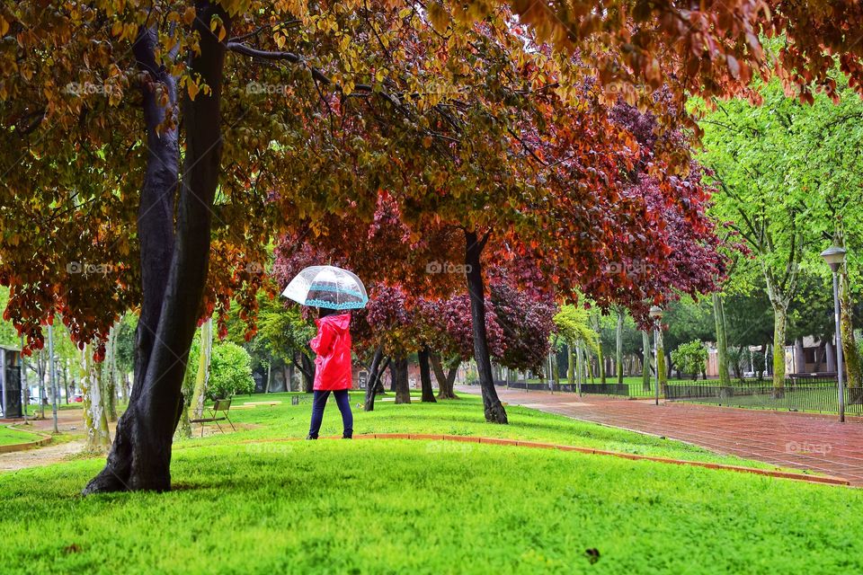 Girl walking at the park on a rainy day