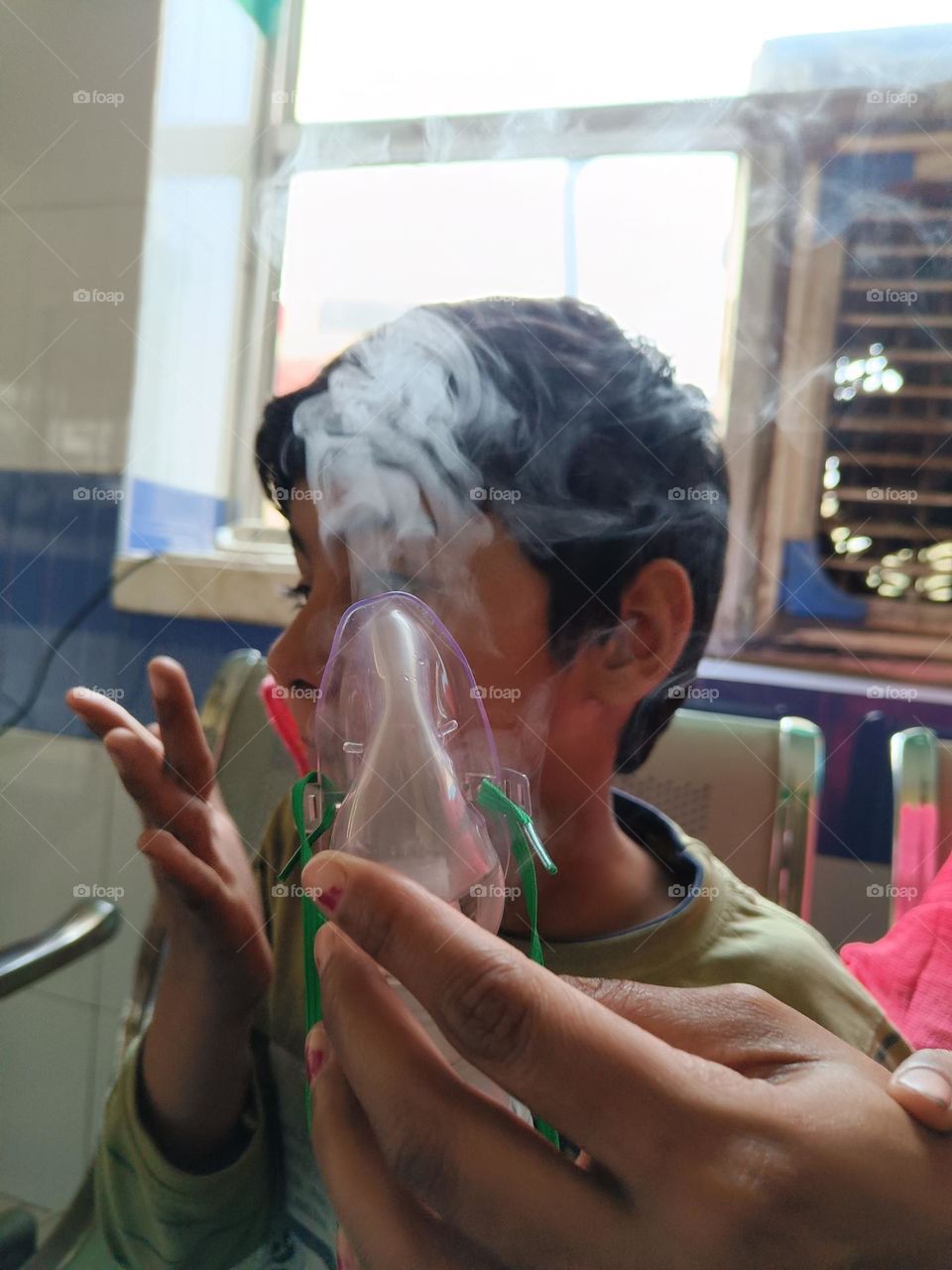 a girl taking medicinal steam for cold treatment.
