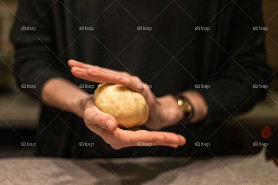 Mid section of woman holding dough