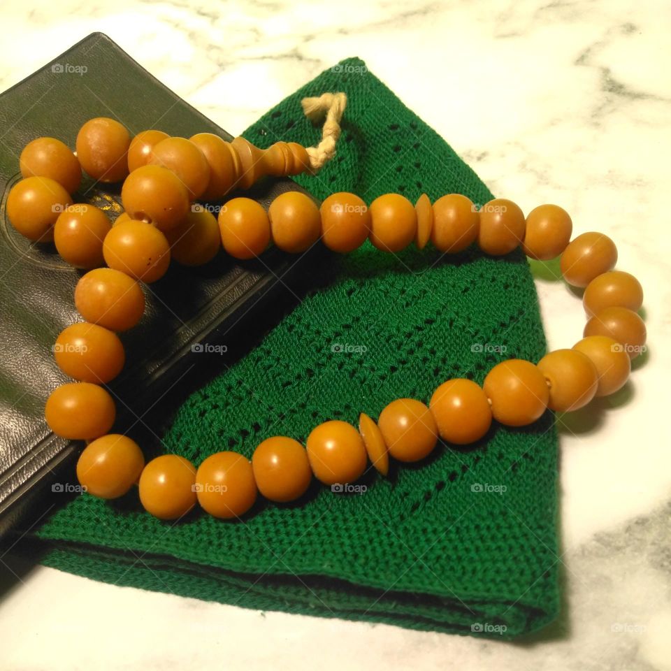 Prayer bead on green cap