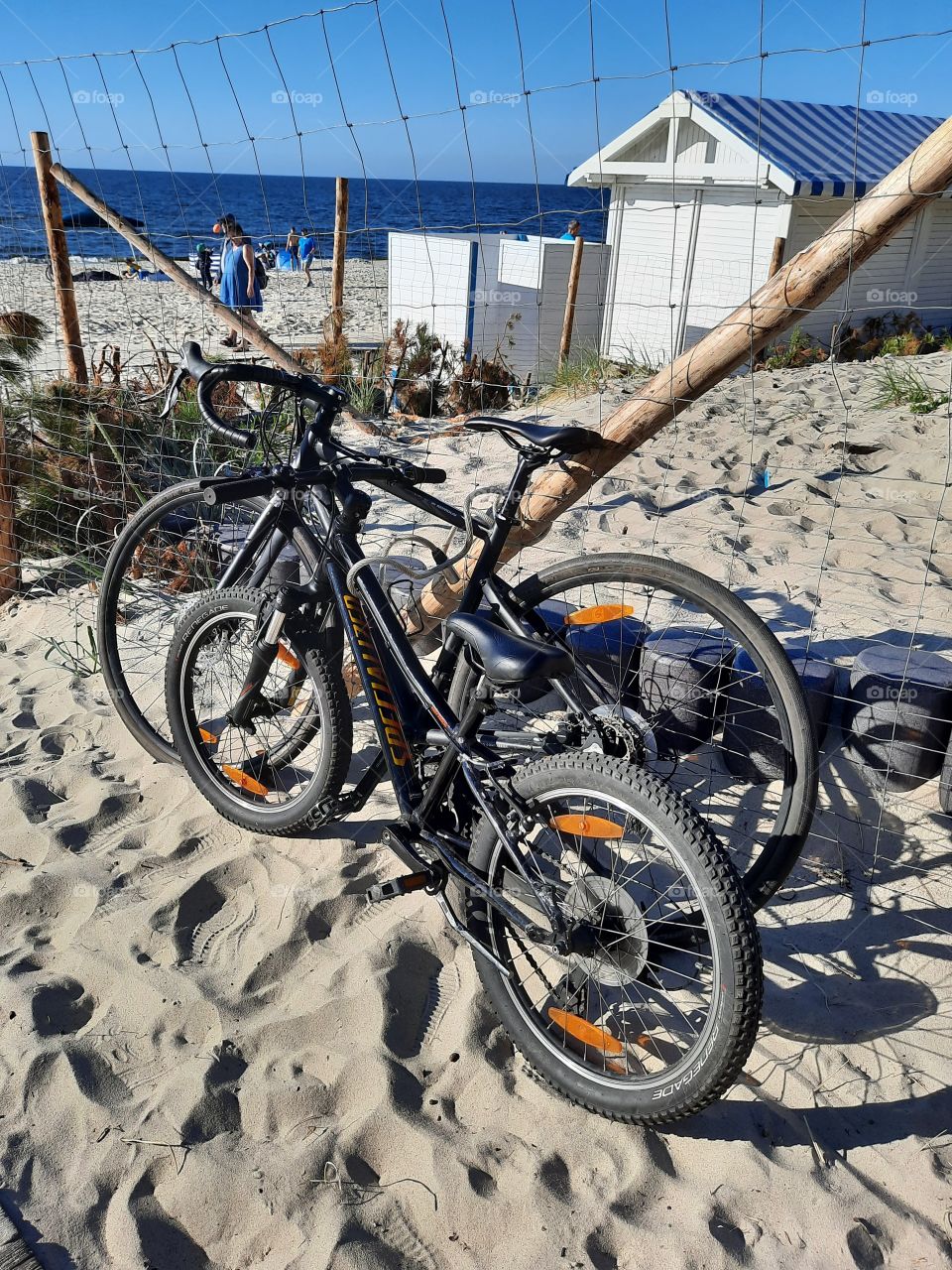 2 black off-road bikes at the beach