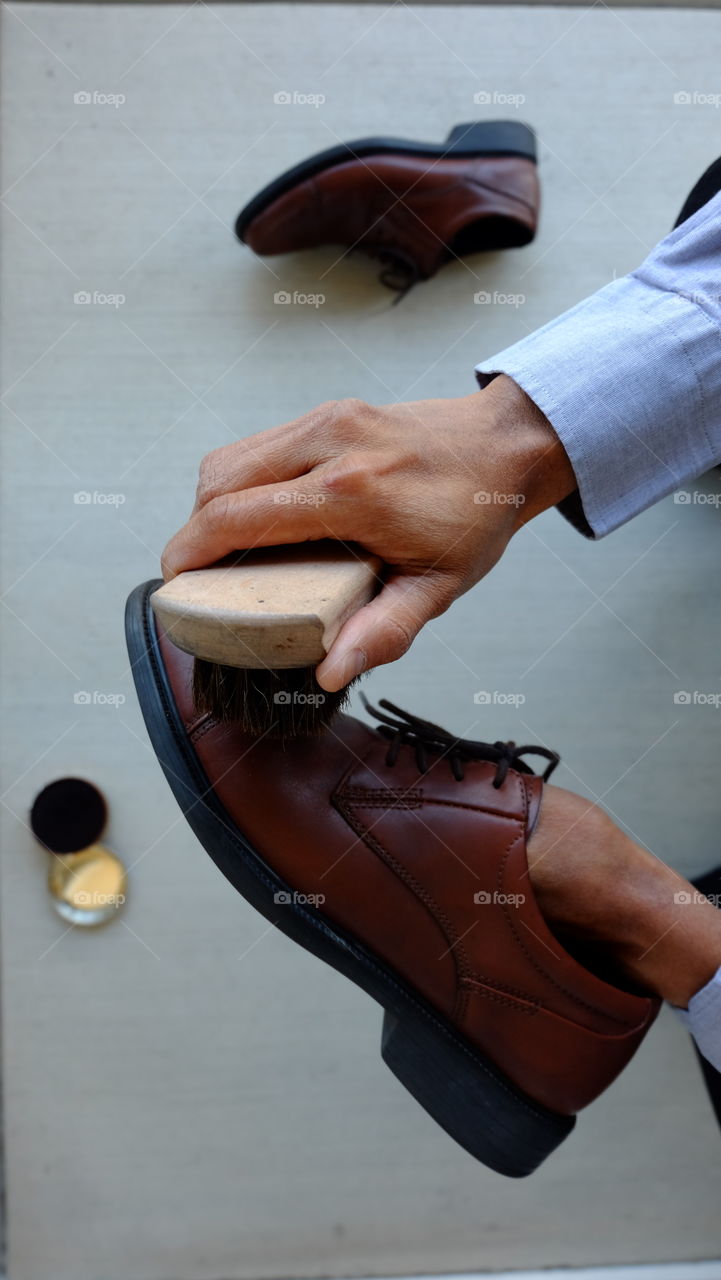 Morning chore, polishing shoes