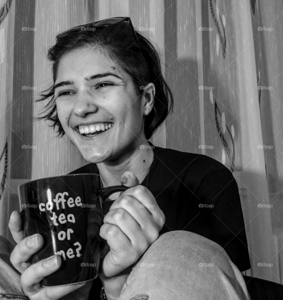 Happy woman holding mug in her hand