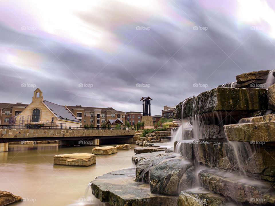 Waterfalls and clouds softened with long shutter speed.  River Walk in Flower Mound, Texas. 