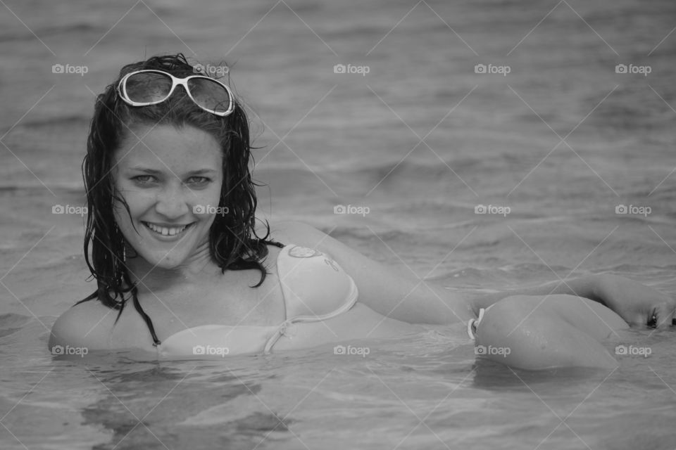 Happy woman lying in sea