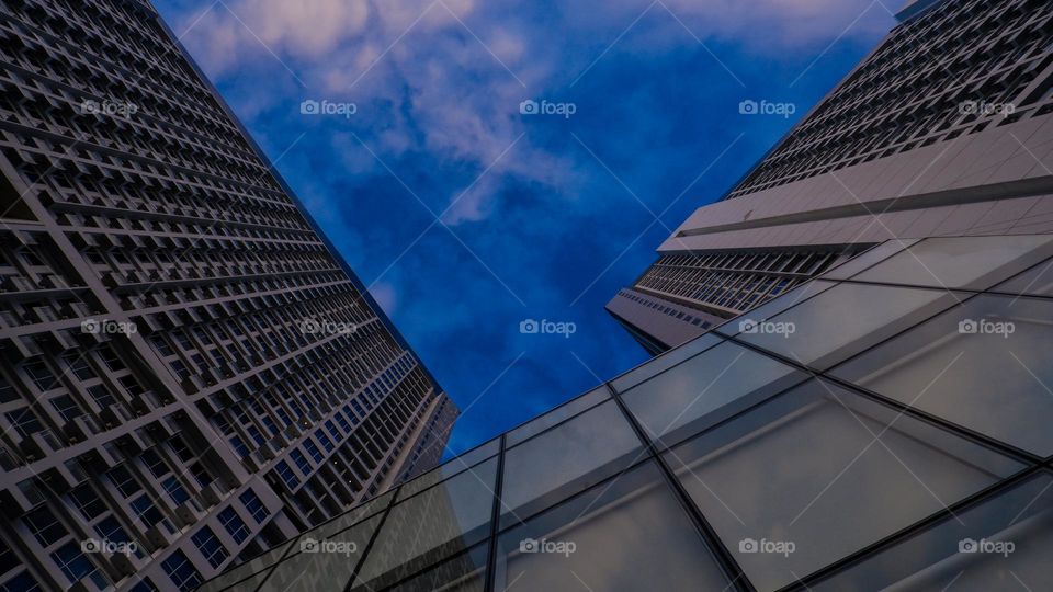 low angle of an apartment against a bright blue sky in the background