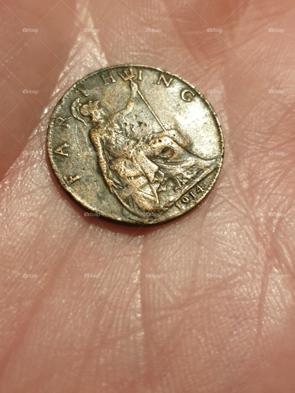 Pre-decimal coin in hand