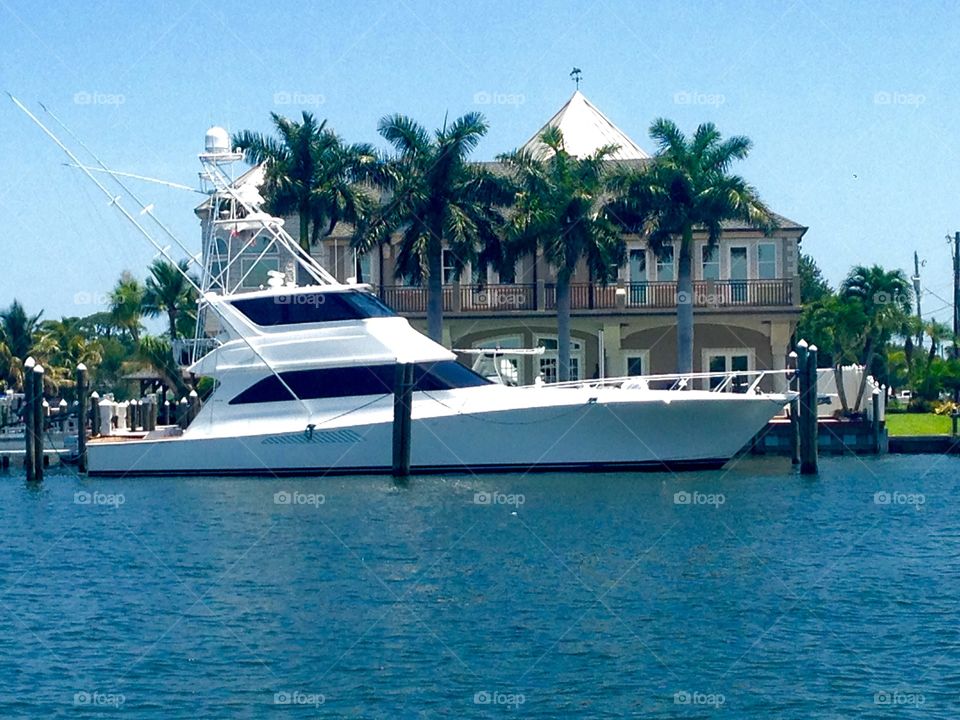 Rich and shameless . Cruisin down the river in our boat and saw this beautiful 65 foot sport fishing yacht and the house isn't too bad either