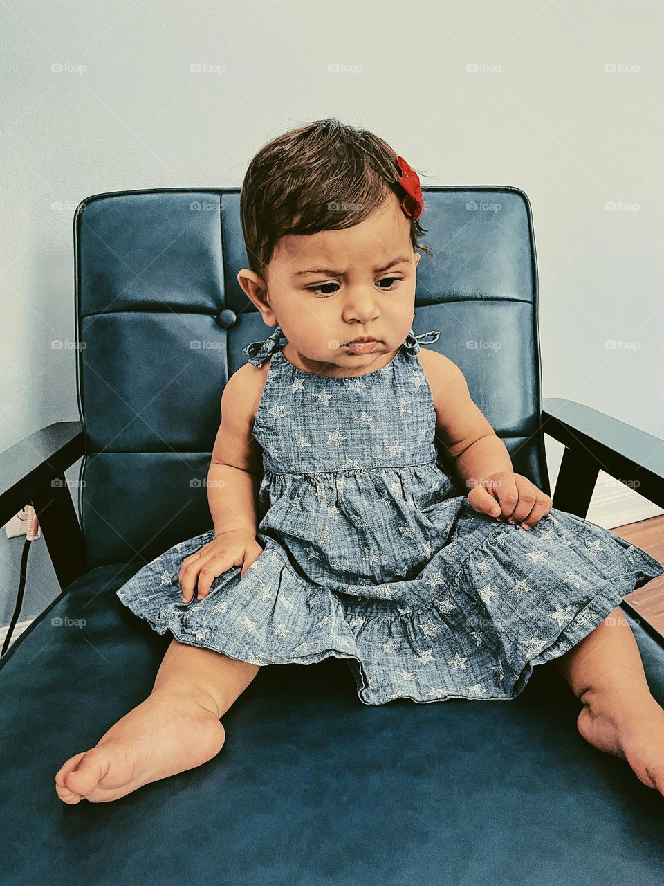 Child is angry sitting in chair, baby girl with angry expression on her face, little girl expressing anger, angry expressions on infants, little girl looks mad, sitting in a chair and being angry, infants expressing emotions 