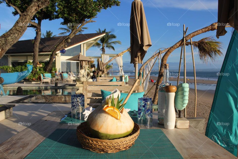 Beautiful coastline views and fancy coconuts in Seminyak resort area of Bali island. 