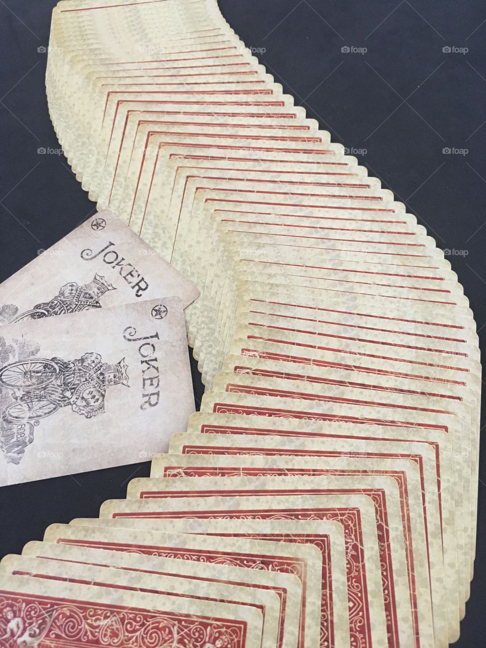 Playing cards spread out on black background