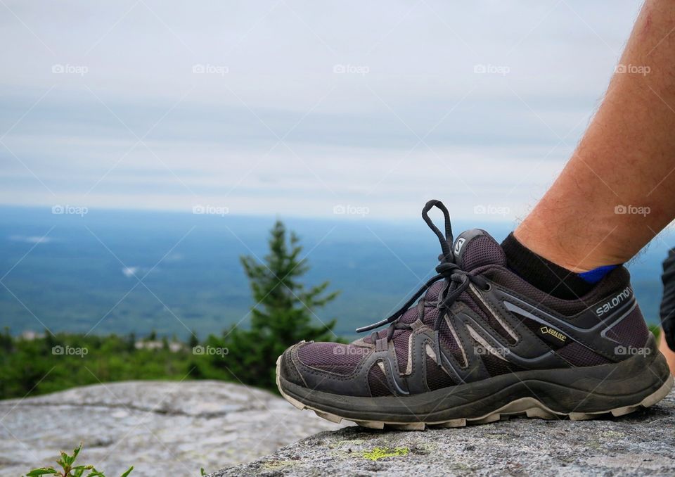 Hiking  shoes  with  mountain  cloudy  view 