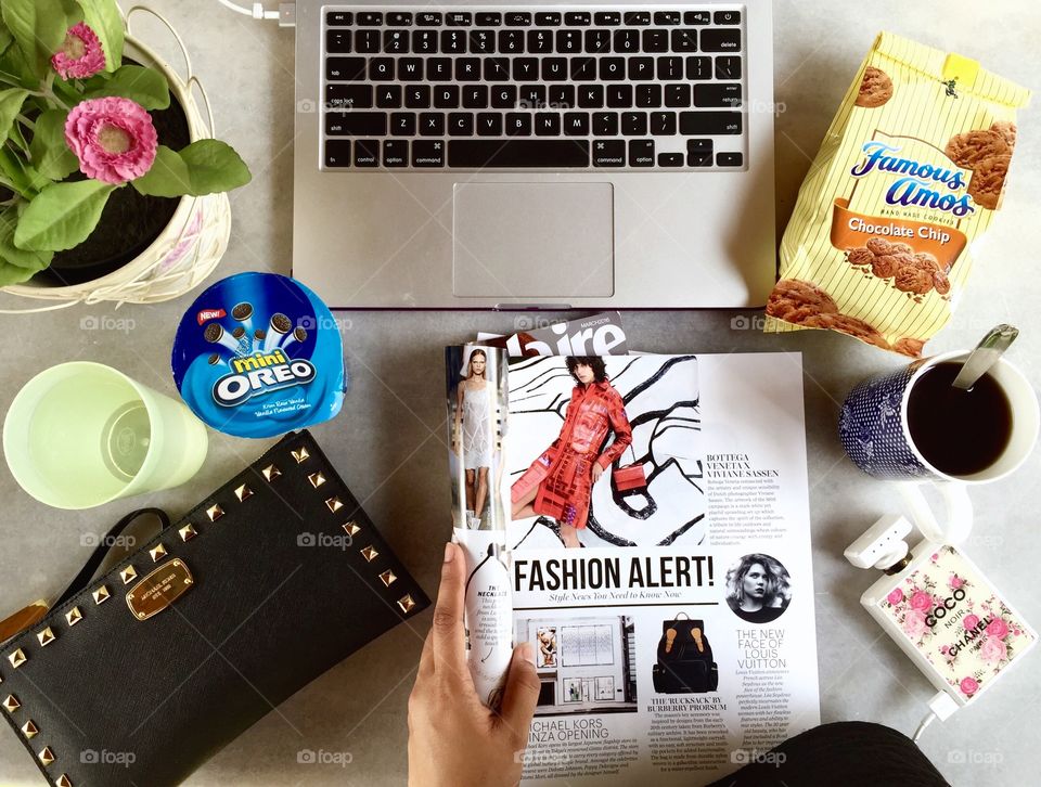 Elevated view of human hand holding magazine