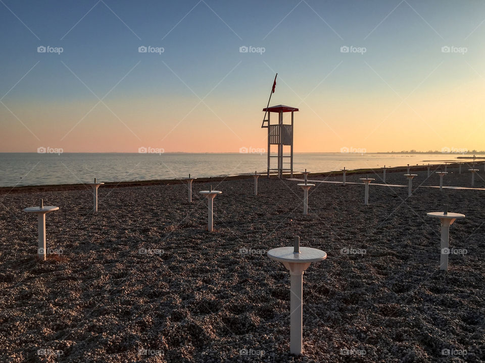 Life guard cabin at beach during sunset