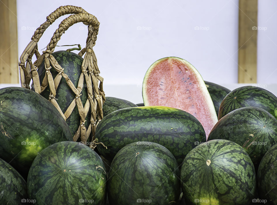 Watermelon lot on the table and put a hand basket