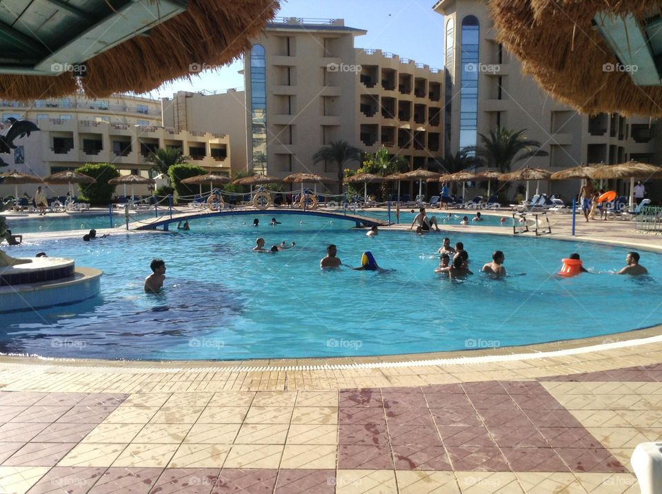 Having fun while swimming in the hotel’s swimming pool 