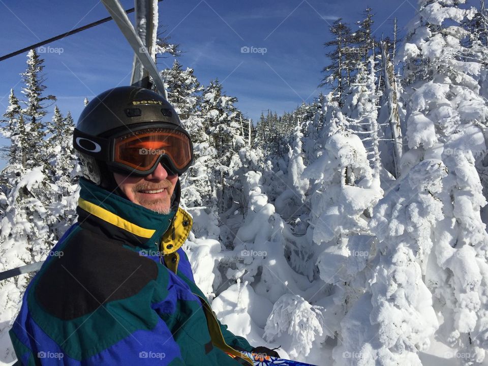 Skier riding chairlift at Cannon Mountain