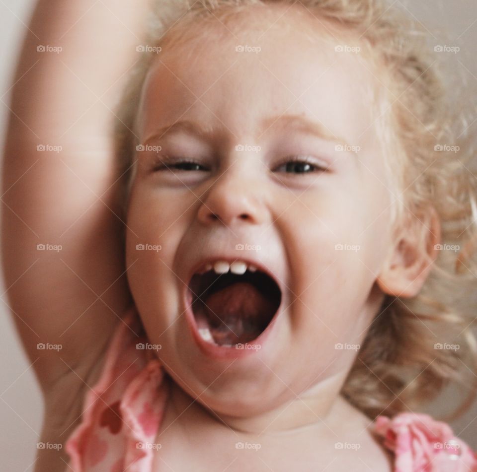 Close-up of a little girl with mouth open