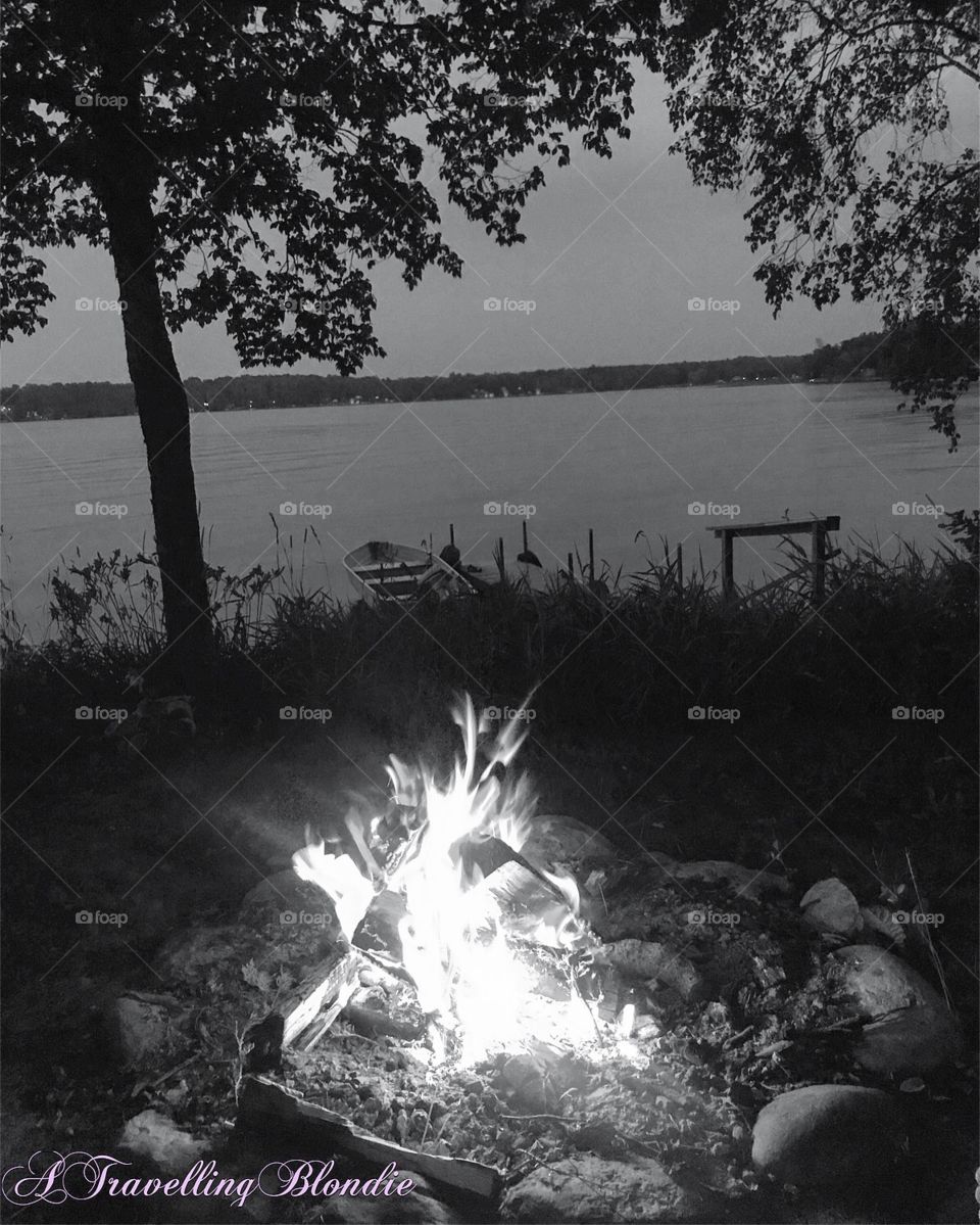 Black and white lakeside campfire