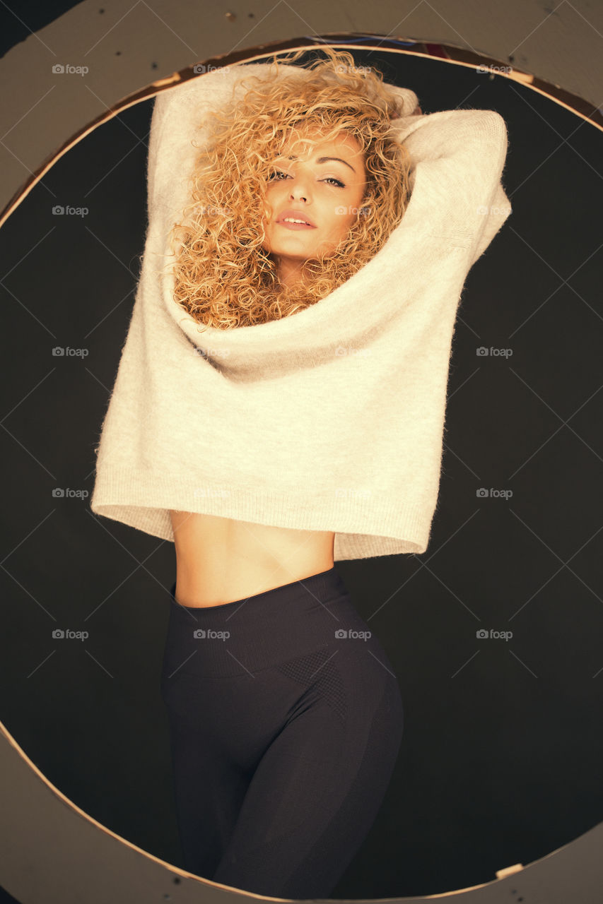 Fashion young woman posing with curly hair