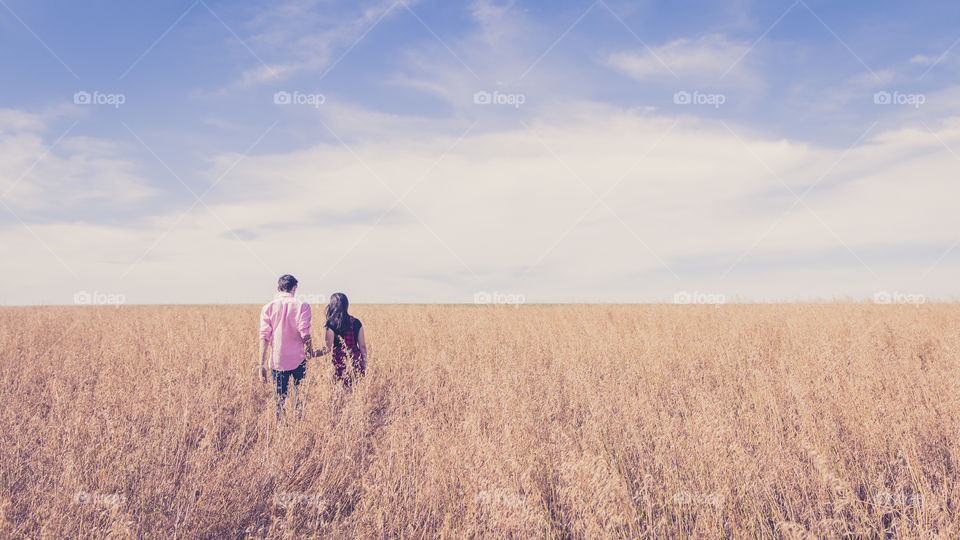 Couple walking in field