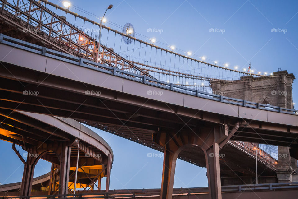 Futuristic highway bifurcation next to the Brooklyn bridge in New York at evening 