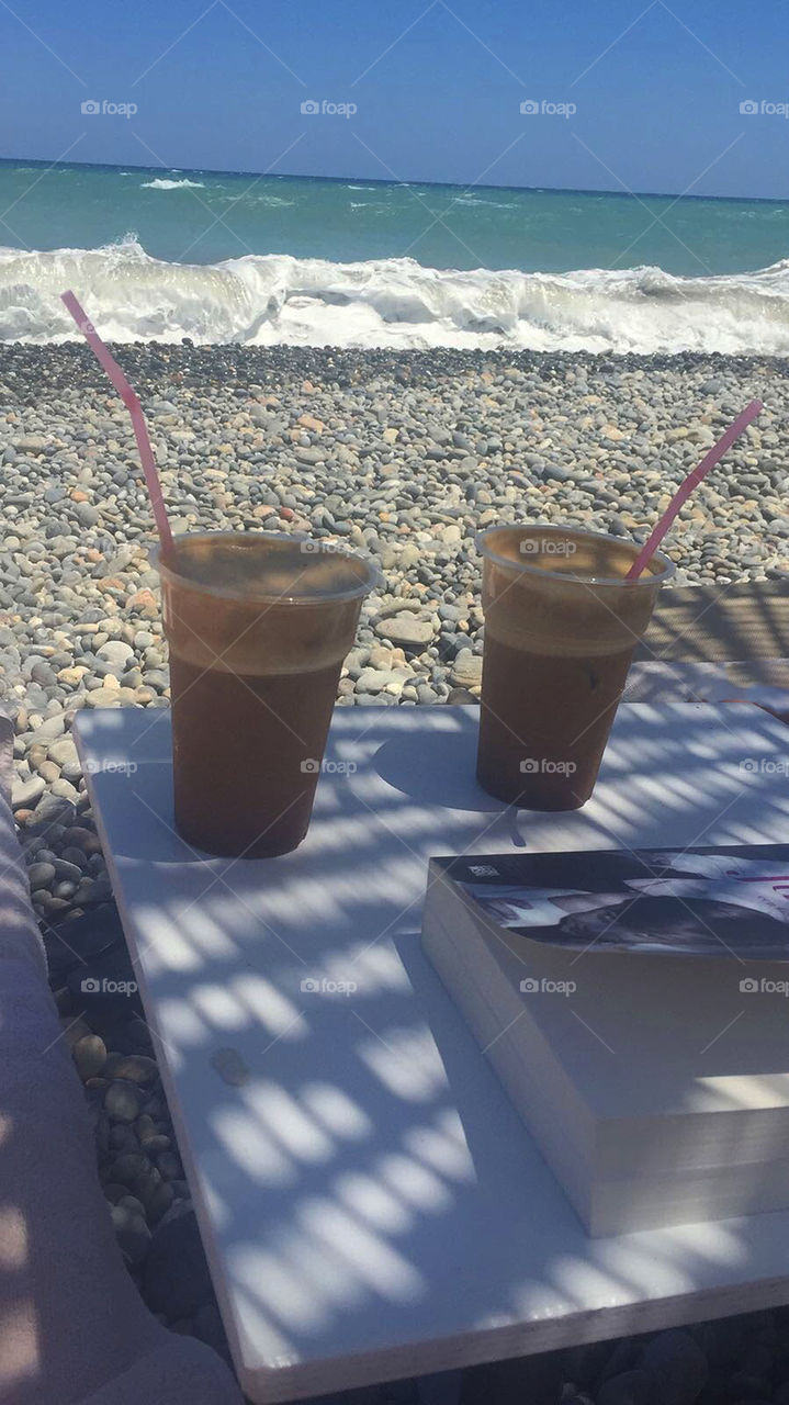 Cold chocolate drink on a hot summer day with beautiful sea view 