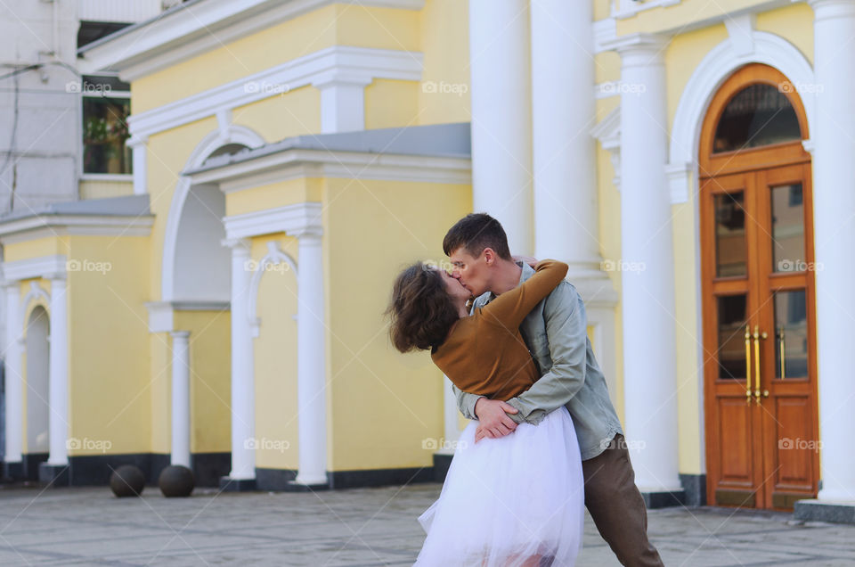 Love story of stylish funny couple. People walking, dancing and kissing in the autumn city. Wedding celebration and date concept.