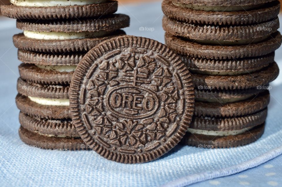 A stack of Oreo cookies on a blue background