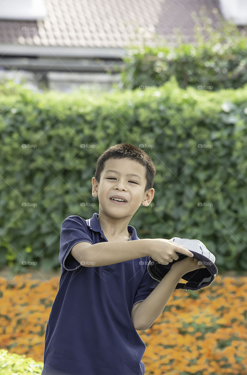 Portrait of Asean boy , laughing and smiling happily in the park.