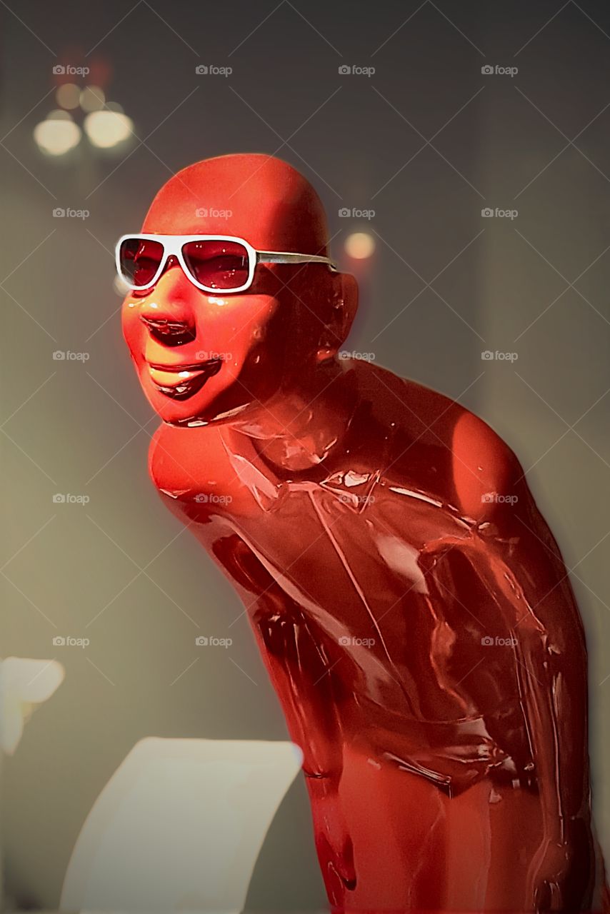 red butler. dummy with white glasses in a n optician shop