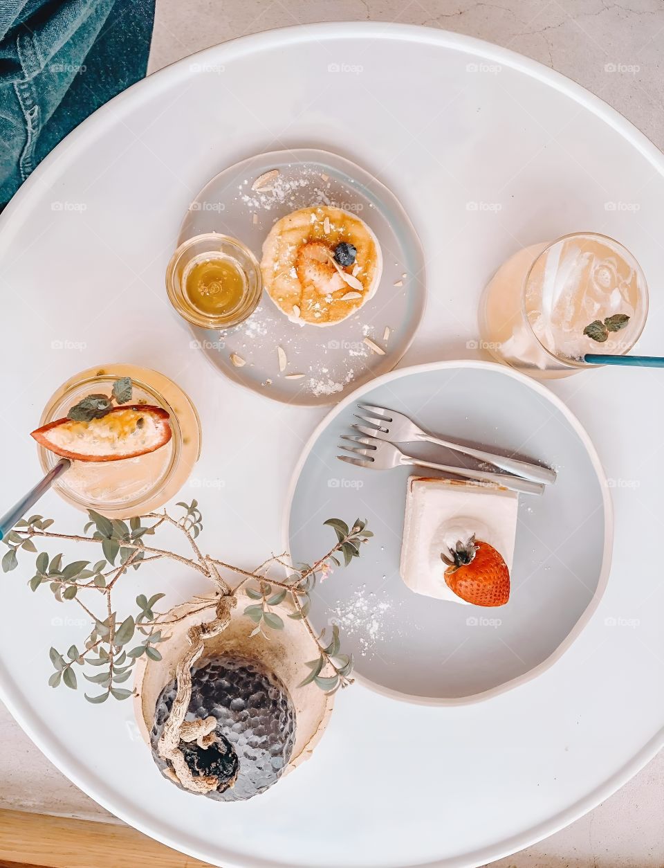 Set of cakes and pancakes on a white table