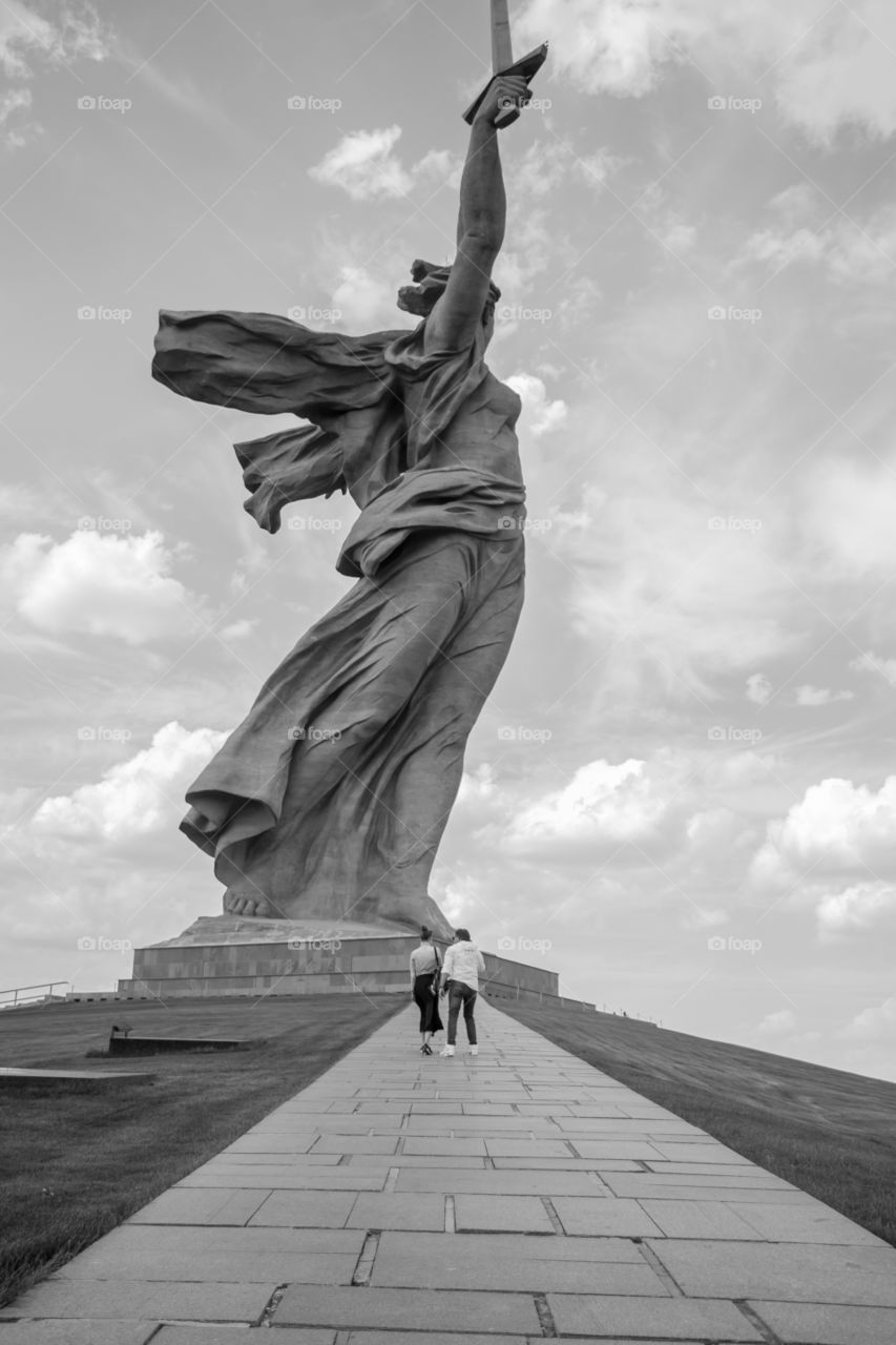 Couple wandering around in the summer visiting the famous Mamayev Kurgan statue