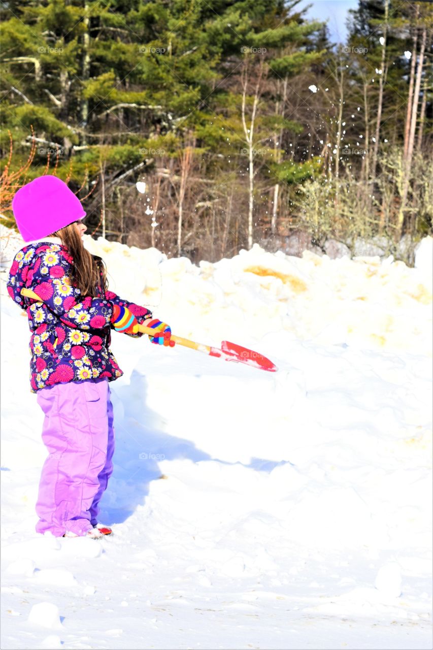 girl shoveling snow