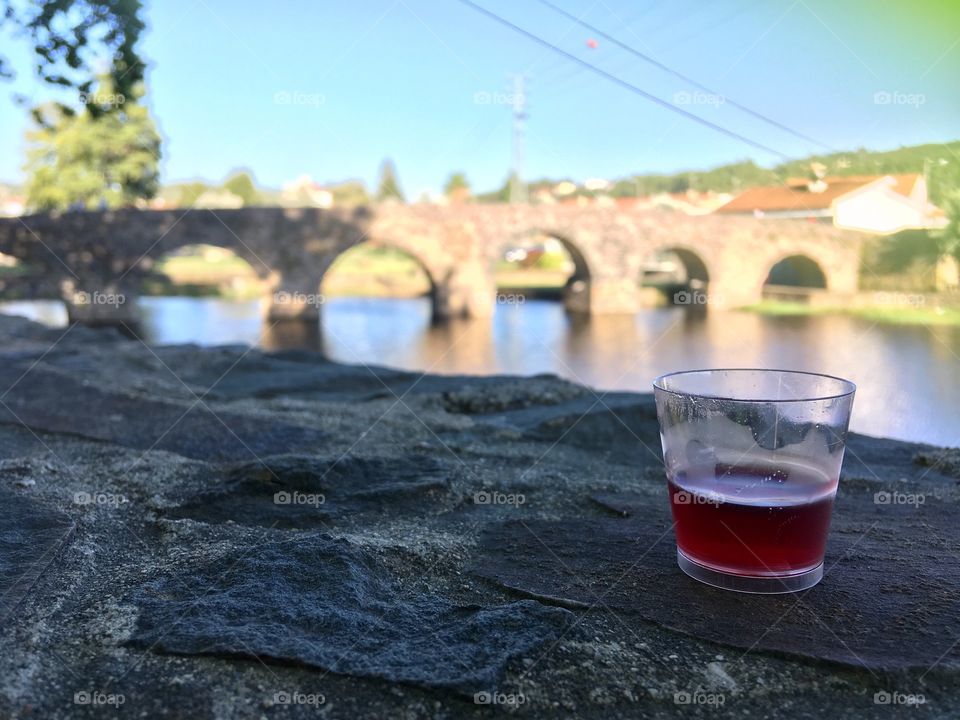 Summer, sunset drink by the bridge 
