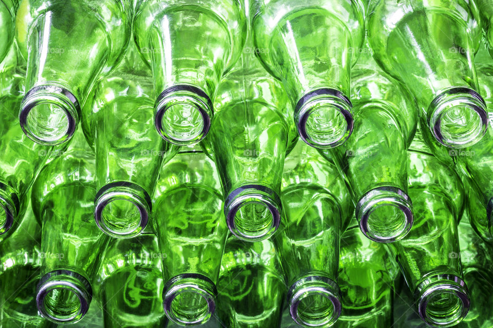 Stack of green color bottles 