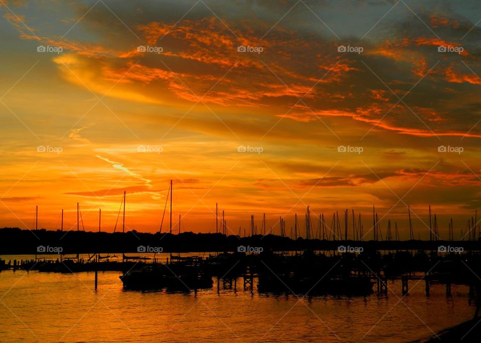 Boat moored on sea during sunset